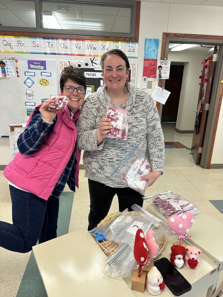 Mrs. Ohmann and Mrs. Houston passing out Cupid Poops